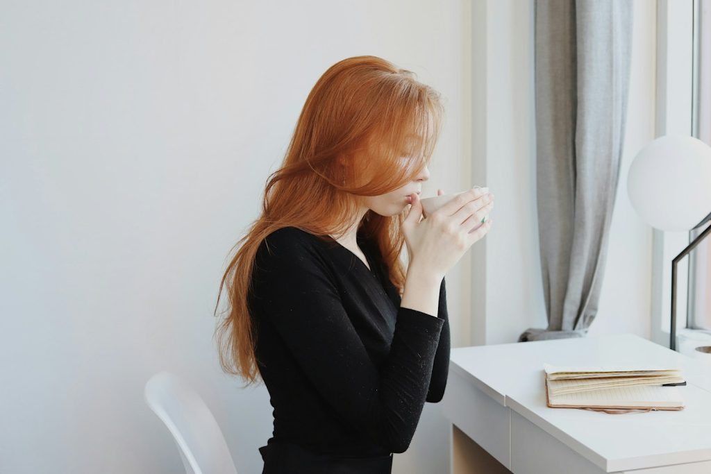 Woman in black long sleeve shirt sitting on chair